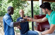 Great Outdoor Pizza Ovens friends drinking near red Alfa Allegro outdoor wood-fired pizza oven