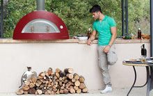 Great Outdoor Pizza Ovens man standing near red Alfa Allegro outdoor wood-fired pizza oven