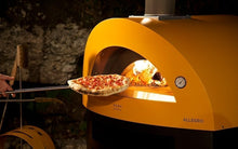 Great Outdoor Pizza Ovens pizza inserted into yellow Alfa Allegro outdoor wood-fired pizza oven